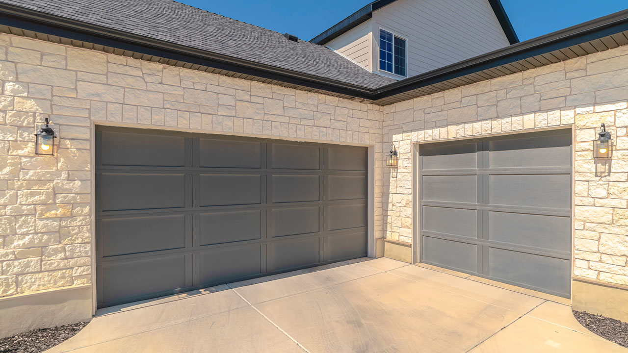 Stone-trim garage doors installed in East Uniontown, PA by Bear Door Services