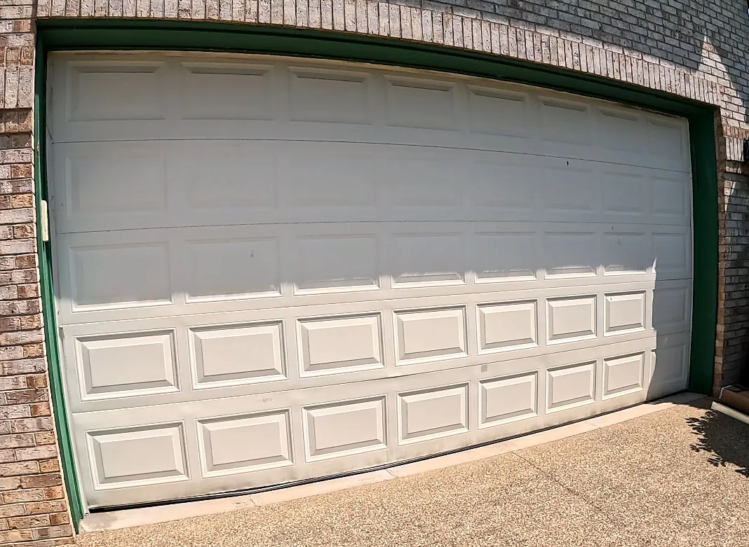 Woodgrain CHI & Brown Trim garage before — Dated doors replaced with woodgrain CHI doors and crisp new brown trim.
