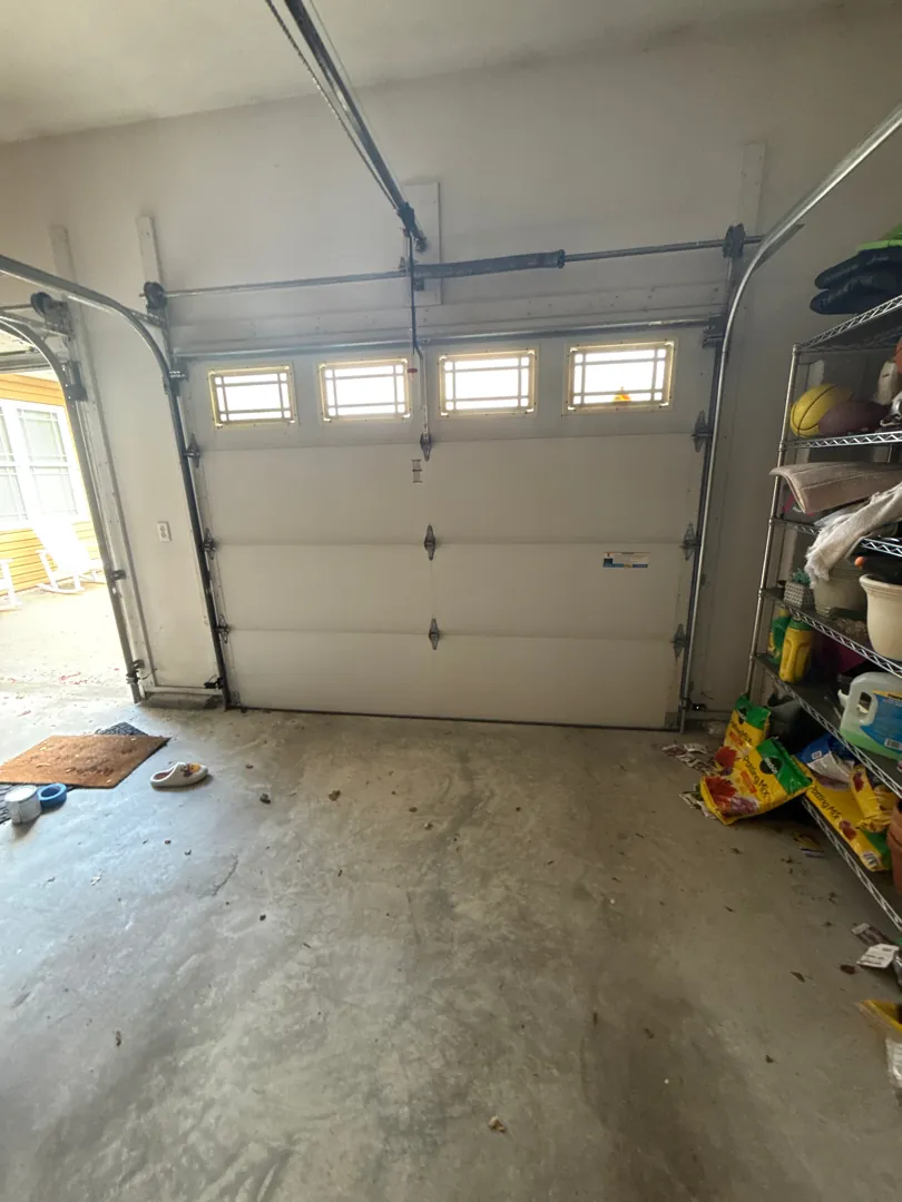Premium Insulated Woodgrain garage before — A full winter curb-appeal refresh with premium insulated woodgrain doors.