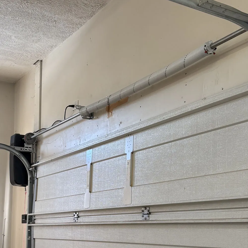 Premium BEARMAX torsion spring mounted above a garage door