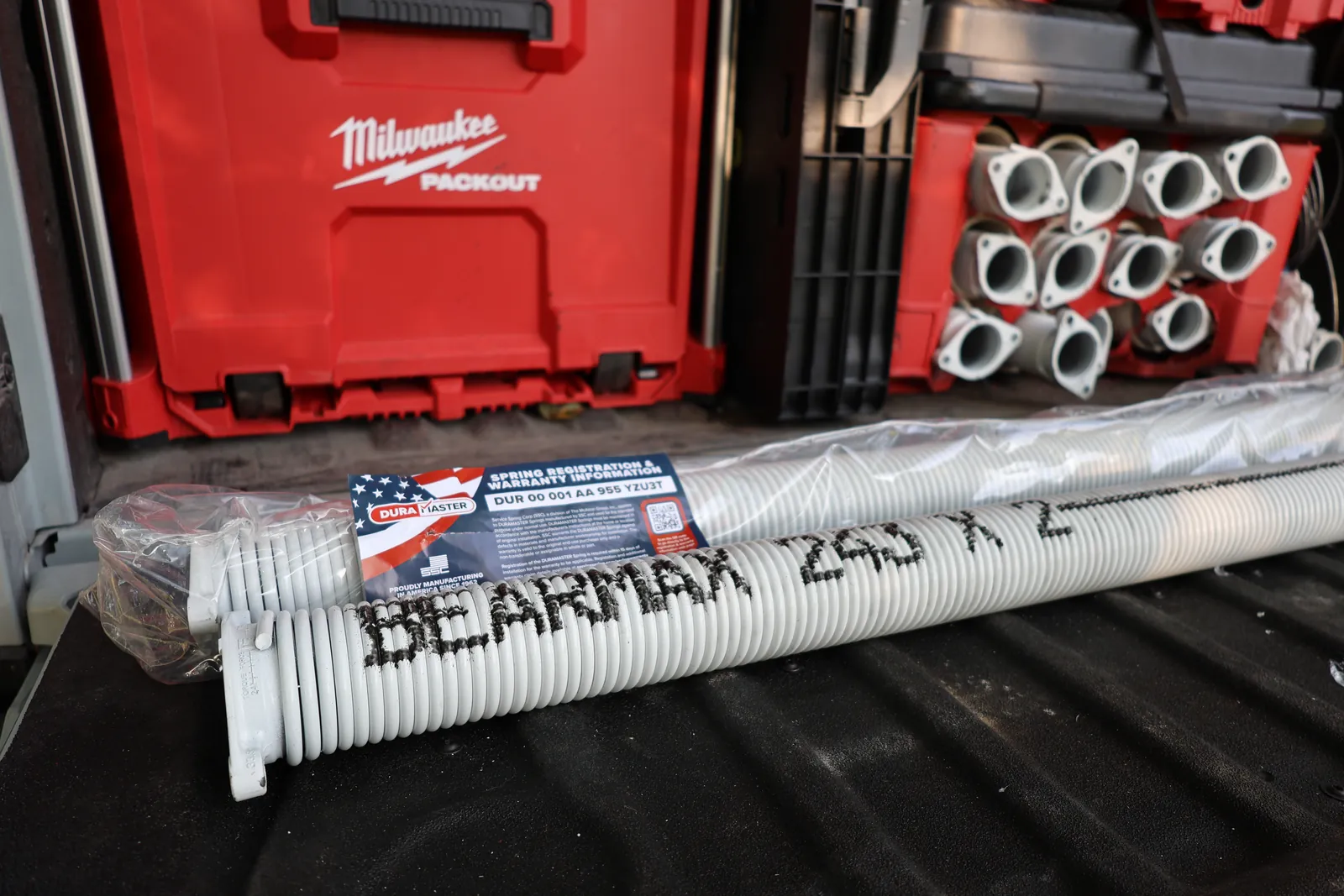 New BEARMAX torsion springs laid out on a truck tailgate