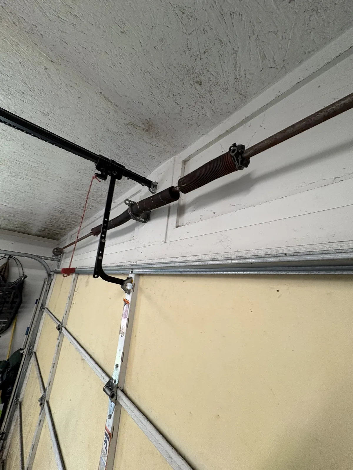 A snapped torsion spring found during a Bear Door Services service call