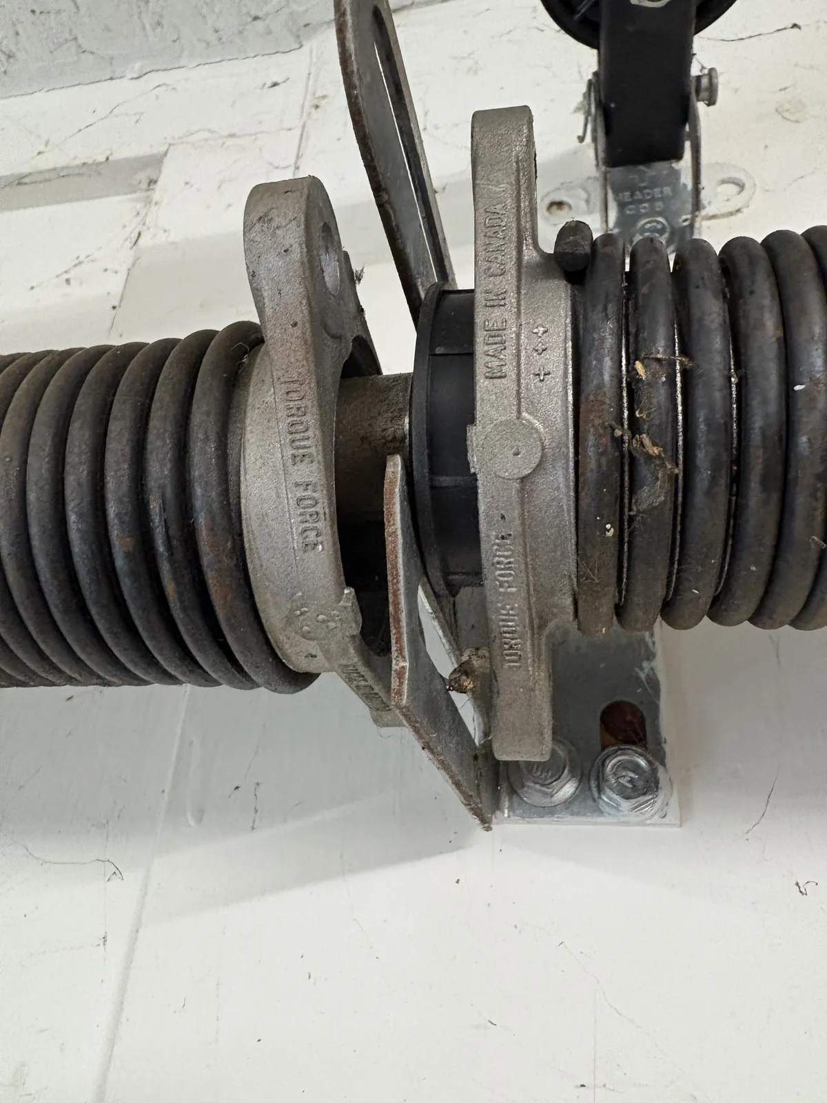 A broken garage door torsion spring inspected by Bear Door Services