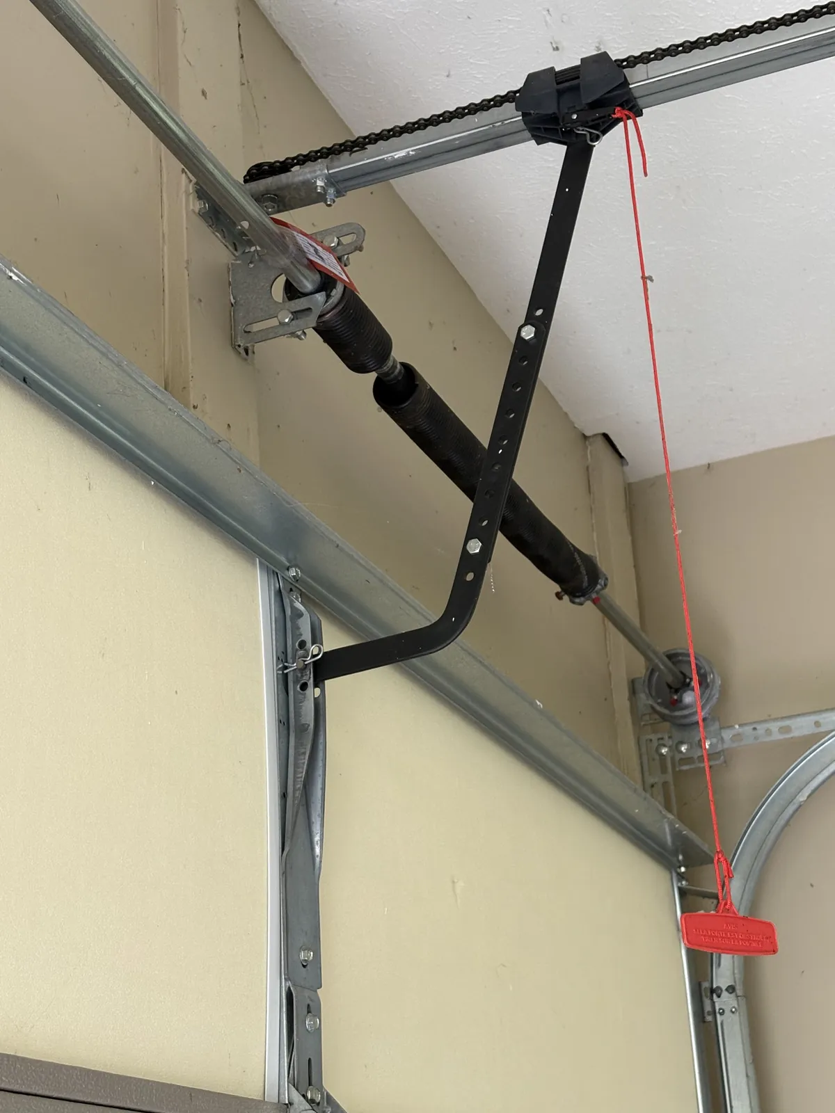 A fresh BEARMAX torsion spring on the door shaft
