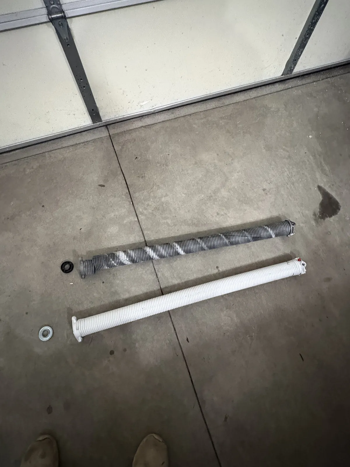 Comparison of worn and new garage door torsion springs